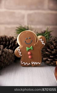 Christmas Homemade gingerbread man cookie waiving a hand saying hello, traditionally made at wintertime and the holidays.