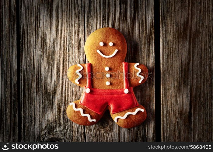 Christmas homemade gingerbread man on wooden table