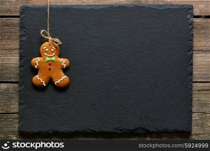 Christmas homemade gingerbread man over slate background