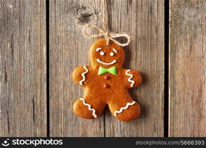 Christmas homemade gingerbread man over wooden background