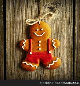 Christmas homemade gingerbread man over wooden background