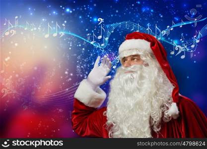 Christmas is coming. Santa Claus enjoying sound of distant music