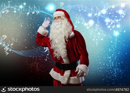 Christmas is coming. Santa Claus enjoying sound of distant music
