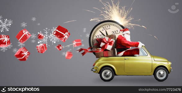 Christmas is coming. Santa Claus on toy car delivering New Year 2022 gifts and countdown clock at gray background with fireworks. Santa Claus 2022 countdown on car