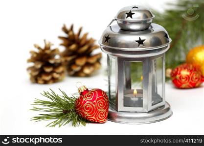 Christmas lantern with Christmas toys and fir tree branches
