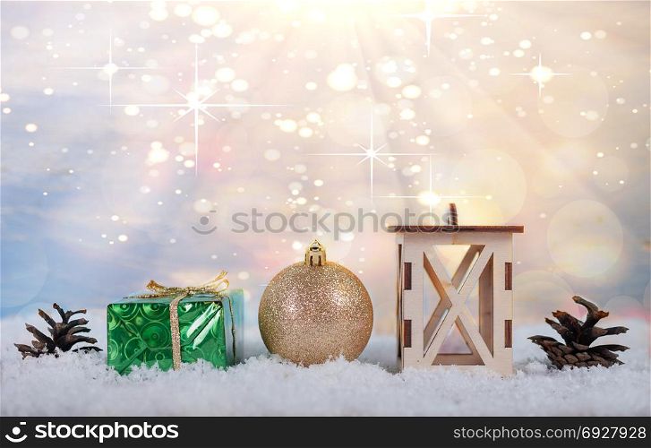 Christmas light background with cones, Christmas toys, boxes and lamps standing in the snow