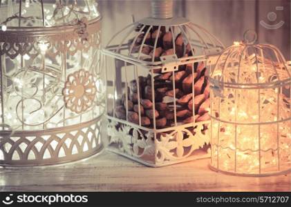 Christmas light decoration in a white bird cage.