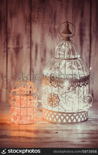Christmas light decoration in a white bird cage.. Christmas light in a cage