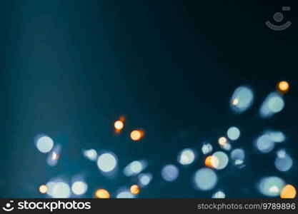 Christmas lights border, bokeh lights over dark background, blurry glowing festoon, New Year greeting card with text space