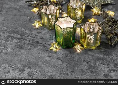 Christmas lights decoration. Candles and shiny stars on dark background stars