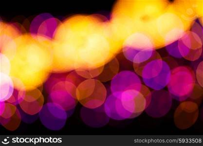christmas lights defocused background. christmas yellow and violet lights bokeh defocused background