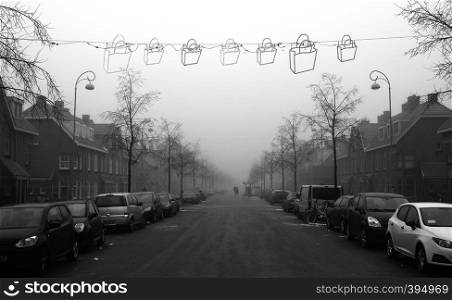 Christmas lights on a street in the mist in winter