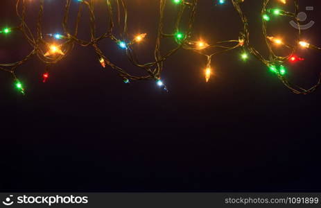 Christmas lights on blue background with copy space