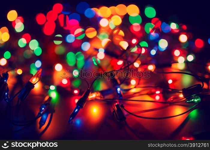 Christmas lights on dark background. Decorative garland. Tinted photo