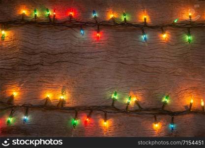 Christmas lights on wooden plank background. Merry Christmas and happy new year with copy space for a text.