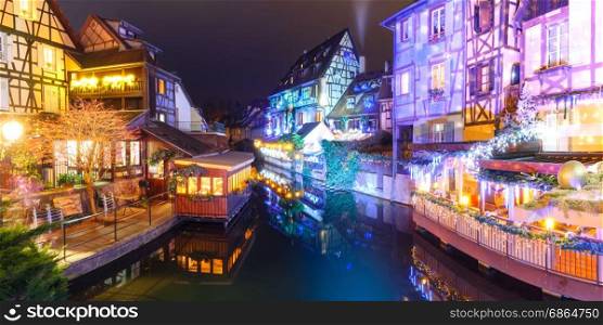 Christmas Little Venice in Colmar, Alsace, France. Panorama of traditional Alsatian half-timbered houses and river Lauch in Petite Venise or little Venice, old town of Colmar, decorated and illuminated at christmas time, Alsace, France