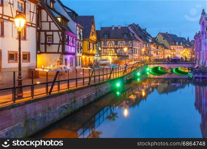 Christmas Little Venice in Colmar, Alsace, France. Traditional Alsatian half-timbered houses and river Lauch in Petite Venise or little Venice, old town of Colmar, decorated and illuminated at christmas time, Alsace, France