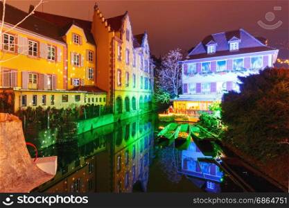 Christmas Little Venice in Colmar, Alsace, France. Traditional Alsatian half-timbered houses and river Lauch in Petite Venise or little Venice, old town of Colmar, decorated and illuminated at christmas time, Alsace, France