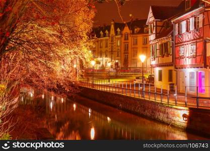 Christmas Little Venice in Colmar, Alsace, France. Traditional Alsatian half-timbered houses in Petite Venise or little Venice, old town of Colmar, decorated and illuminated at snowy christmas night, Alsace, France