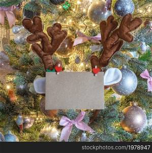 Christmas mail envelope with blank letter in decorated tree with reindeer ears for copy space close to, background, Holiday concept space for text. Christmas mail envelope with blank letter in decorated tree with reindeer ears for copy space close to, background, Holiday concept
