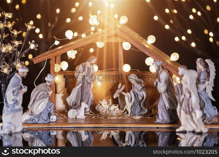 Christmas Manger scene with figurines including Jesus, Mary, Joseph, sheep and wise men. Focus on baby!