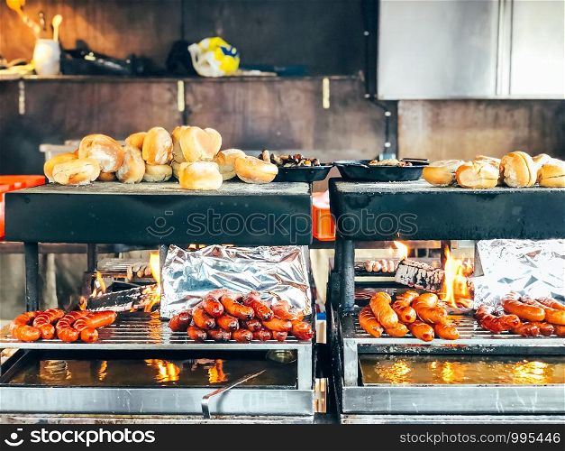 Christmas market in Germany, Europe. Traditional bratwurst sausages and bread on grill during outdoor seasonal Christmas market in Munich