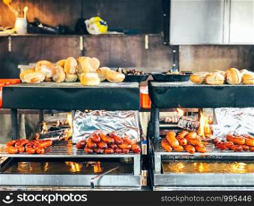 Christmas market in Germany, Europe. Traditional bratwurst sausages and bread on grill during outdoor seasonal Christmas market in Munich