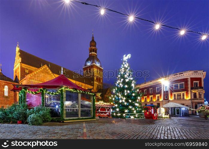 Christmas Market in Riga, Latvia. Decorated and illuminated Christmas tree, Christmas Market and the Cathedral of Saint Mary at Cathedral Square, Doma laukums, Riga, Latvia.