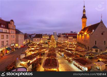 Christmas Market in Tallinn, Estonia. Decorated and illuminated Christmas tree and Christmas Market at Town Hall Square or Raekoja plats, Tallinn, Estonia. Aerial view