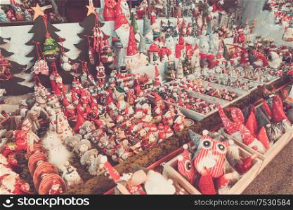 Christmas market kiosk details - traditional festive figurines decorations, retro toned. Christmas market kiosk details