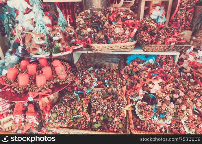 Christmas market kiosk details with christmas wreath and candles, retro toned. Christmas market kiosk details