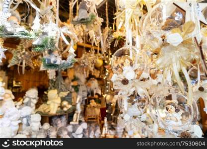 Christmas market kiosk details with hanging christmas tree decorations with angels. Christmas market kiosk details