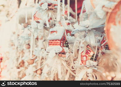 Christmas market kiosk details with hanging christmas tree decorations with angels, retro toned. Christmas market kiosk details