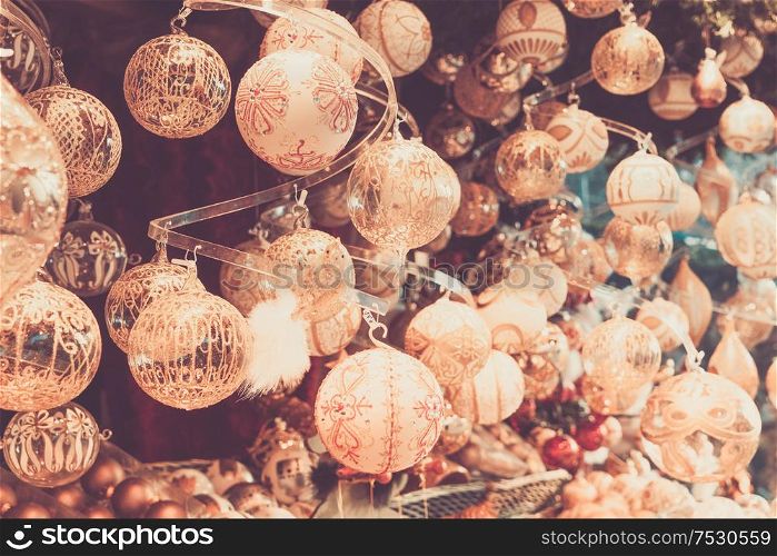 Christmas market kiosk details with wide choice of christmas golden tree decorations, retro toned. Christmas market kiosk details