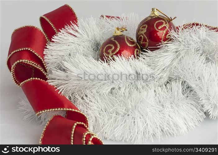 Christmas motifs with balls and chains. Red and white balls, white chains and red ribbon