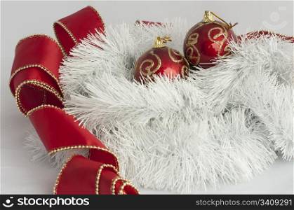 Christmas motifs with balls and chains. Red and white balls, white chains and red ribbon