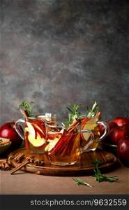 Christmas mulled apple cider with cinnamon, anise and rosemary. Traditional hot drink or beverage, festive Xmas or New Year winter cocktail