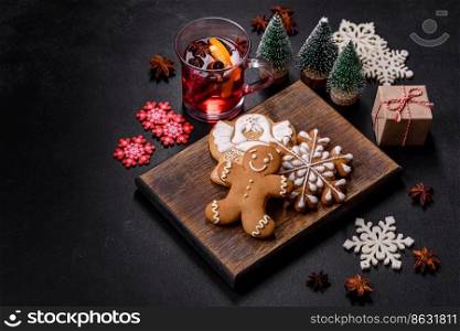 Christmas mulled red wine with spices and fruits on a concrete table. Traditional hot drink at Christmas time. Christmas mulled red wine with spices and fruits on a concrete table