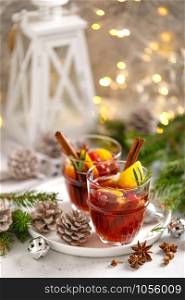Christmas mulled wine. Traditional Xmas festive drink with decorations and fir tree