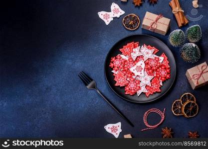 Christmas, New Year, DIY, holidays preparation and creativity concept. Getting ready to celebration. Christmas decorations and gingerbreads on a dark concrete table. Preparing and decorating the house for holiday