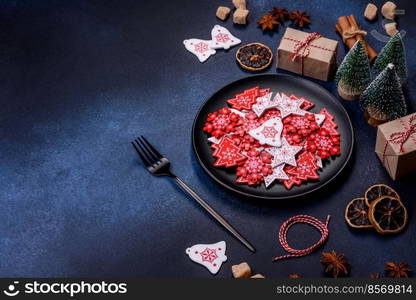 Christmas, New Year, DIY, holidays preparation and creativity concept. Getting ready to celebration. Christmas decorations and gingerbreads on a dark concrete table. Preparing and decorating the house for holiday