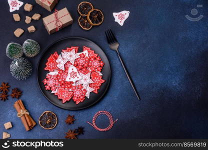 Christmas, New Year, DIY, holidays preparation and creativity concept. Getting ready to celebration. Christmas decorations and gingerbreads on a dark concrete table. Preparing and decorating the house for holiday