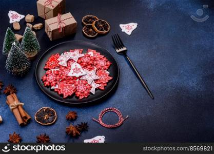 Christmas, New Year, DIY, holidays preparation and creativity concept. Getting ready to celebration. Christmas decorations and gingerbreads on a dark concrete table. Preparing and decorating the house for holiday