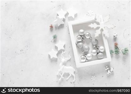 Christmas, New Year or Noel holiday festive decorations, ornaments - balls, snowflakes, stars, deer, bells and balls on white background, flat lay composition, greeting Xmas card, top view