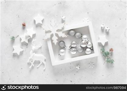 Christmas, New Year or Noel holiday festive decorations, ornaments - balls, snowflakes, stars, deer, bells and balls on white background, flat lay composition, greeting Xmas card, top view