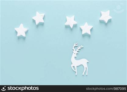 Christmas, New Year or Noel holiday festive winter greeting card, stars and snowflakes on blue background, flat lay composition, top view