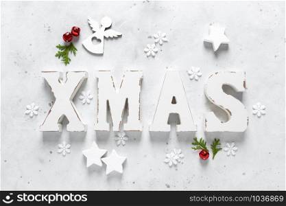Christmas, New Year or Noel holiday festive winter greeting card with decorations, X-mas ornaments, stars, snowflakes, santa hat and Xmas bells on white background, flat lay composition, top view
