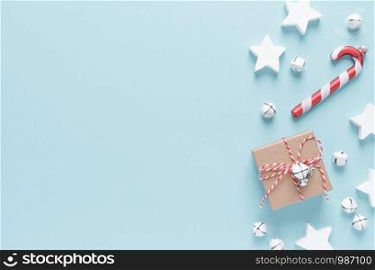 Christmas, New Year or Noel holiday festive winter greeting card with decorations, gift, x-mas ornaments, stars and xmas bells on blue background, flat lay composition, top view, space for text