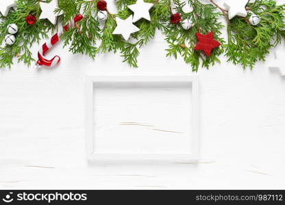 Christmas, New Year or Noel holiday festive winter greeting card with decorations, frame, x-mas ornaments, stars and xmas bells on white background, flat lay composition, top view