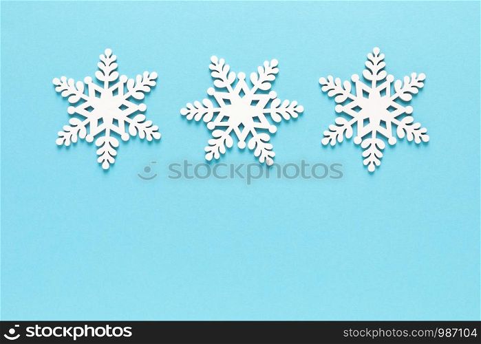 Christmas, New Year or Noel holiday festive winter greeting card with xmas decorations, snowflakes on blue background, x-mas flat lay composition, top view, copy space